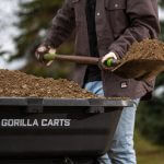 Close up of a man shoveling dirt in 7GCG-NF