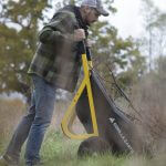 man dumping contents from a GCR-7 on the ground