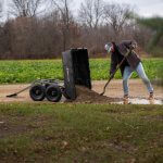 a man from distance pulling dirt out of a GOR-10H